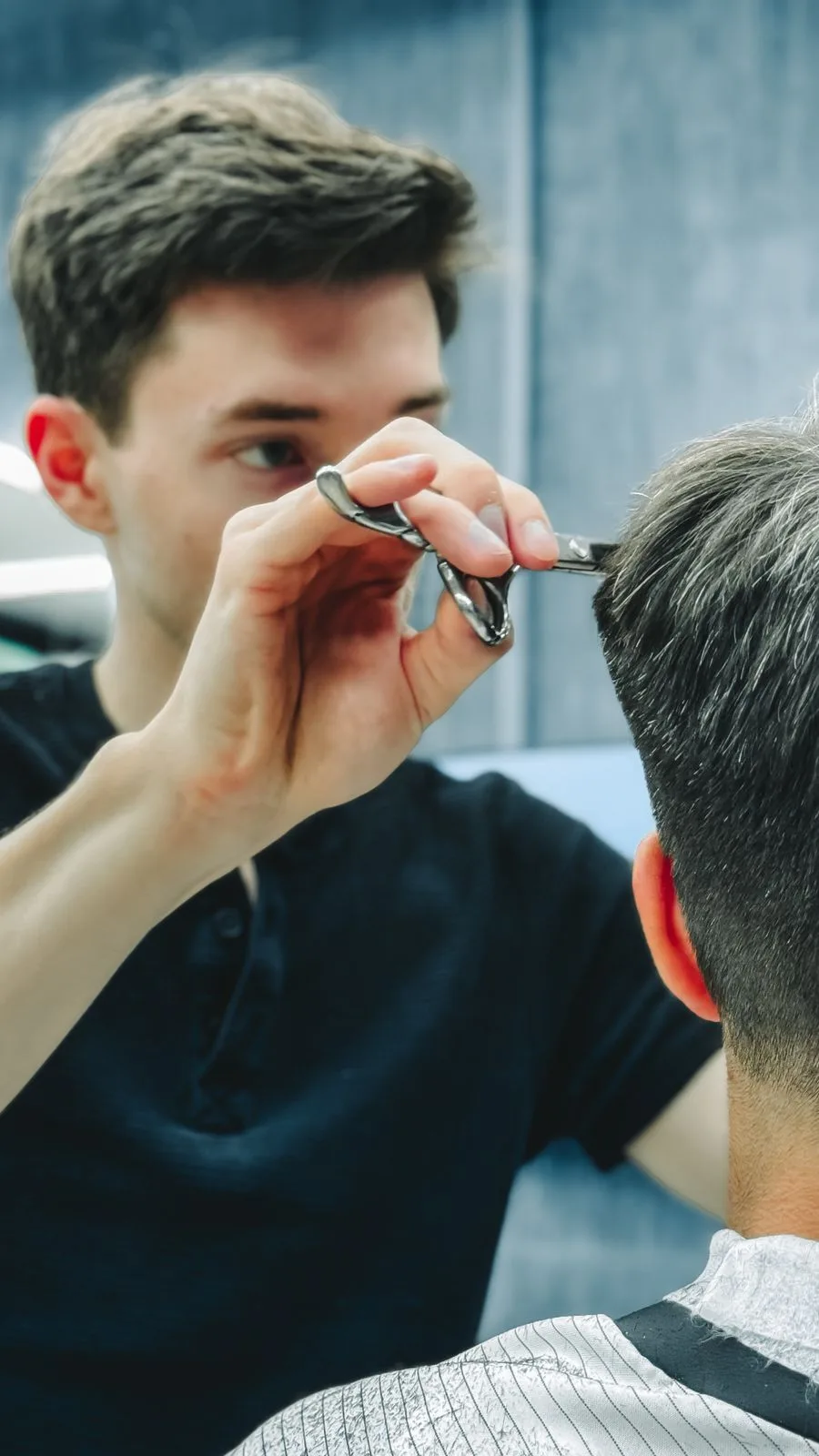 A stylist cutting hair in a salon. Clear communication prevents most bad cuts